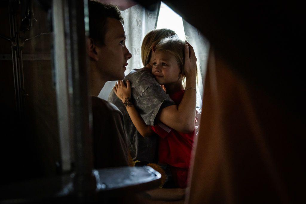 A child cries as they hug their mother prior to the departure of an evacuation train from Pokrovsk, Donetsk Oblast, Ukraine