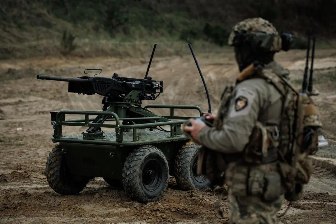 Ukrainian soldiers of the 214th Separate Assault Battalion OPFOR operate the Rys Pro unmanned ground vehicle platform equipped with a remote-controlled machine-gun turret during training in Ukraine in Spring 2025