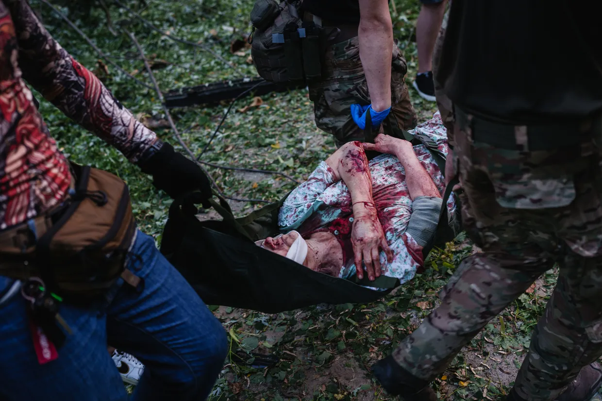 Medics carry a wounded woman on a stretcher after a Russian drone and missile strike in Kyiv, Ukraine, on June 17, 2025. (Serhii Korovainyi)