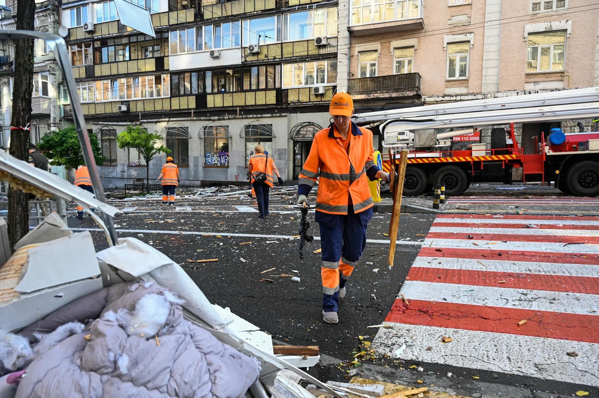 A communal worker is seen working at the site of a Russian attack that damaged a residential building in Kyiv, Ukraine in July 2025