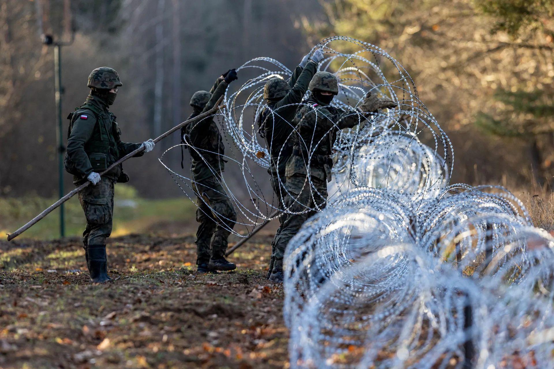 Soldiers of the Polish army install concertina wire at the border with the Russian exclave Kaliningrad in Goldap, Poland