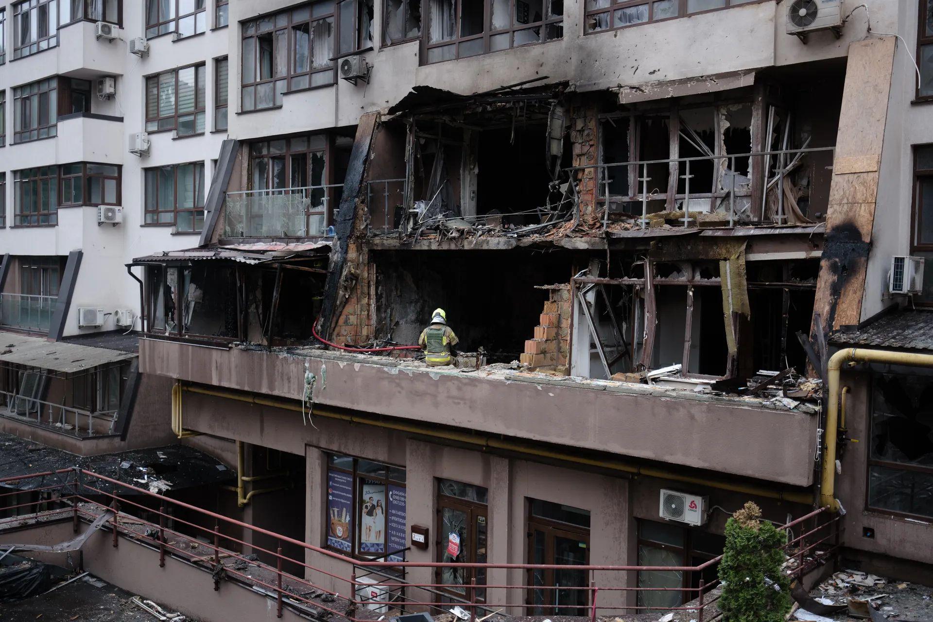 Firefighters work in a damaged residential building after a Russian attack in Kyiv, Ukraine in Summer of 2025