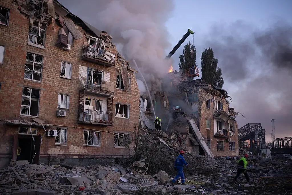 Firefighters extinguish a fire at a destroyed building after a Russian drone-and-missile attack in Kyiv, Ukraine, Aug, 2025