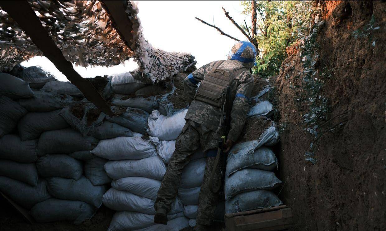 Ukrainian soldier Oleksandr "Tsyrkul" looking onto no man's land at infantry positions in Donetsk Oblast