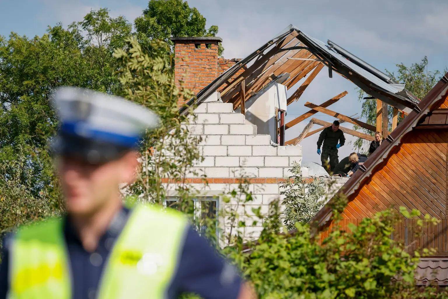 Police and army inspect the damage to a house destroyed by debris from a Russian drone shot down during a mass overnight attack in Wyryki-Wola, Poland, Sept. 10, 2025